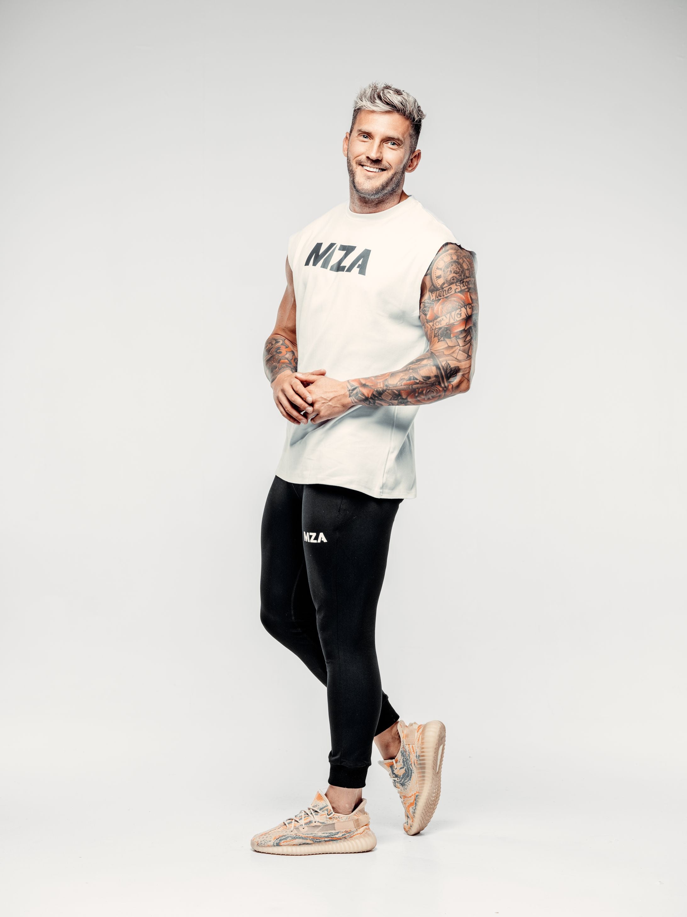 Shane is in a relaxed posed wearing the new standard vest in white