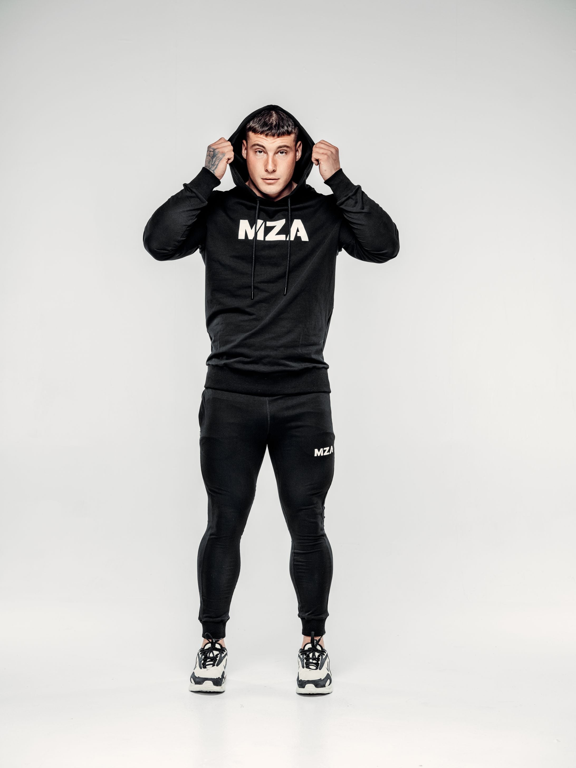 This is lewis wearing the new standard hoodie and new standard joggers black two piece.  He is showing off the fit of the hood, pulling it up over his head