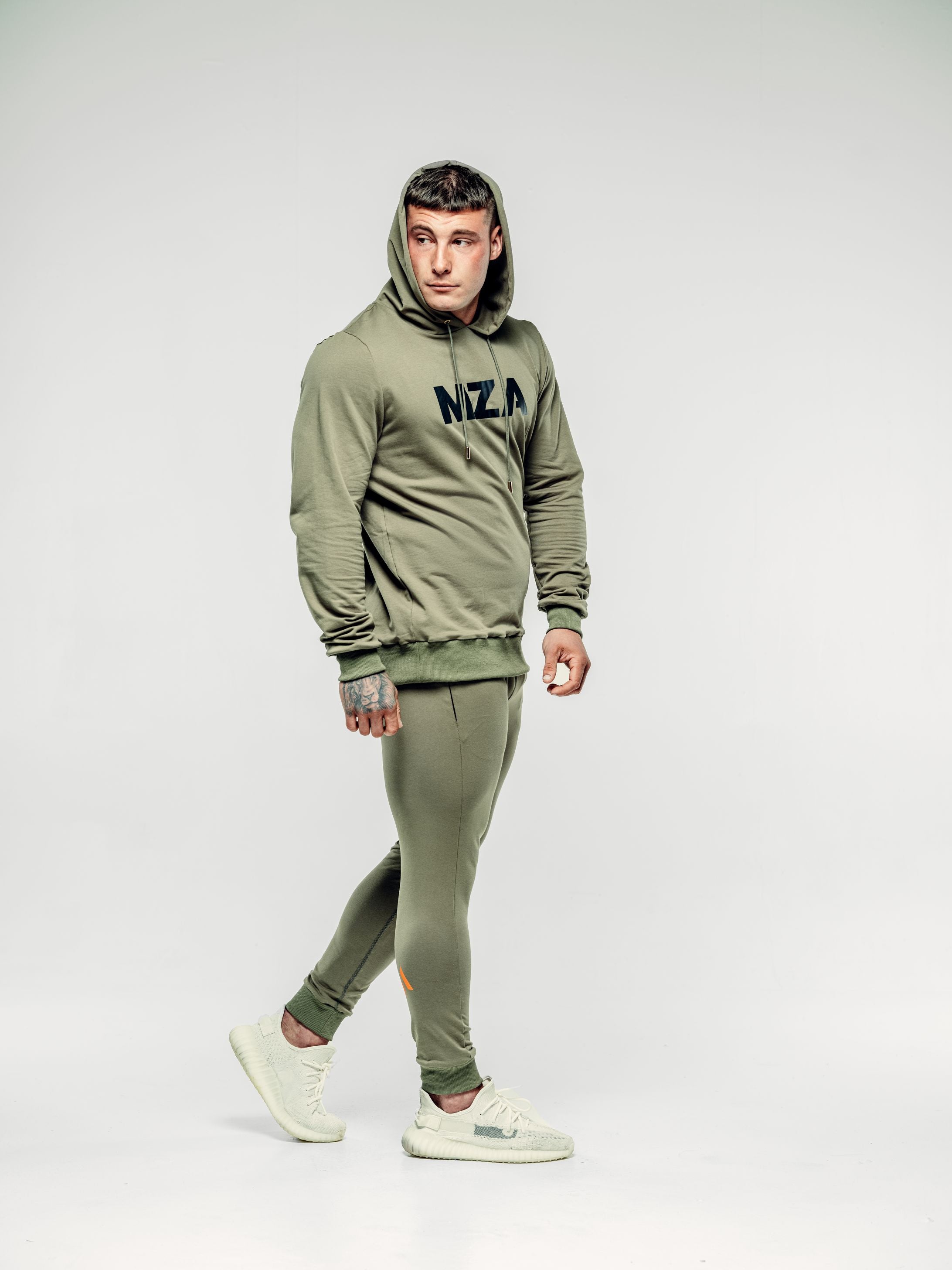 This is lewis wearing the new standard hoodie and new standard joggers khaki.  It's a side on image of Lewis walking.
