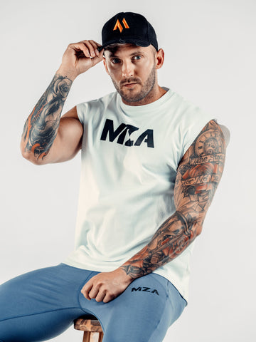 This is Shane wearing the new standard 3d distressed 5 panel in black.  It features the M emblem in orange.  Shane is holding on to the peak with his right hand.  Shane is also wearing the new standard vest in white which features the MZA logo on his chest and the new standard joggers in blue.