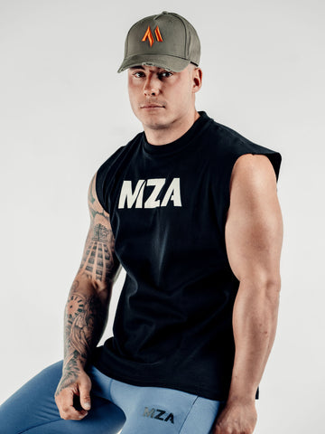 This is Lewis sat slightly angled looking into the camera with the new standard 3d distressed 5 panel in khaki.  Lewis is also wearing the new standard vest in black and the new standard joggers in blue