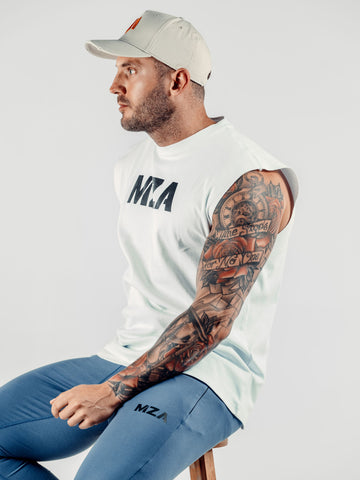 This is Shane sat slightly angled looking straight forward wearing the new standard 3d distressed 5 panel stone.  Shane is also wearing the new standard vest in white and the new standard joggers in blue